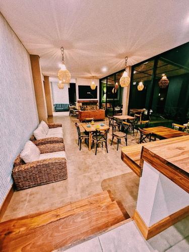 a living room with a couch and tables and chairs at Casa Hotel Bremen in Circasia