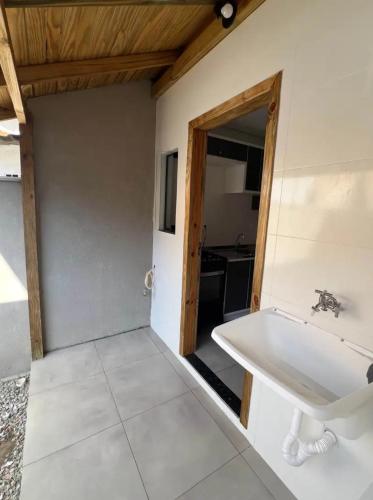 a bathroom with a white tub and a sink at Casa Rebello - Pousada in Itajaí