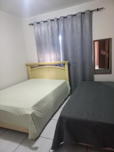 Katil atau katil-katil dalam bilik di Casa de praia com jacuzzi
