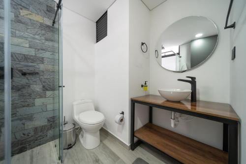 a bathroom with a sink and a mirror at Epic Suites x Ahead in Pereira