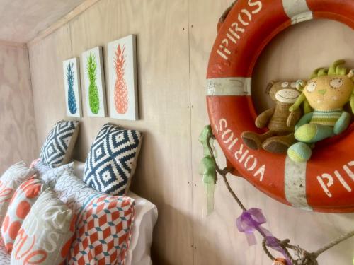 a room with a life saving ring on the wall at Iconic 70's Kiwi Bach in Whitianga