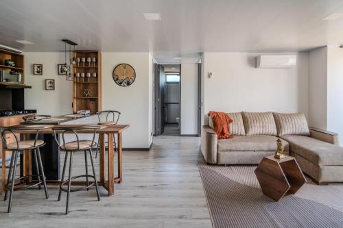 a living room with a couch and a table at Epic Suites x Ahead in Pereira