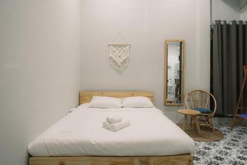 a bedroom with a bed with two teddy bears on it at De Rivé Homestay Cần Thơ in Can Tho