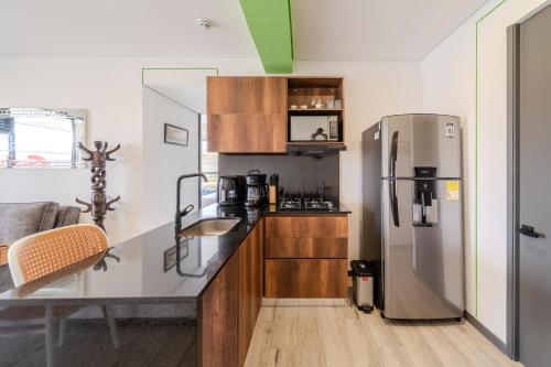 a kitchen with a stainless steel refrigerator and a counter at Epic Suites x Ahead in Pereira