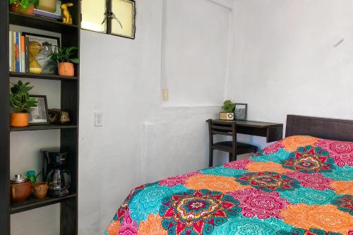 a bedroom with a bed with a colorful blanket at Habitación acogedora in Oaxaca City