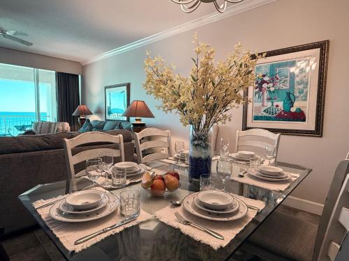 a dining room with a table and a couch at Paradise Found Direct Gulf Front 2 bedroom Condo in Navarre