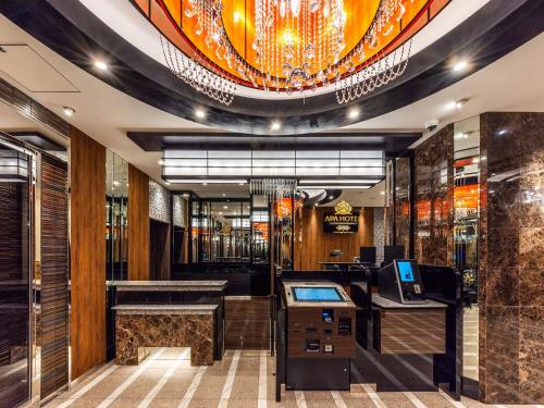 a lobby of a bar with a chandelier at APA Hotel Tokyo Nishikasai Ekimae in Tokyo