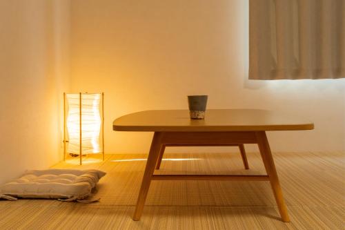 a table in a room with a dog sleeping under it at 瑞の宿浅草 in Tokyo
