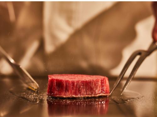a red sponge sitting on a table with two spoons at One Station Hotel Kumamoto -DLIGHT LIFE & HOTELS- in Kumamoto