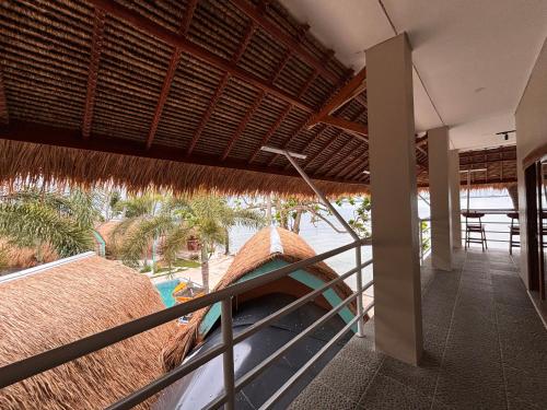 a balcony of a resort with a swimming pool at MAI LAKU Cottage in Sekotong