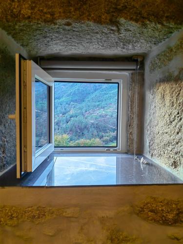 a window in a room with a view of a mountain at Vale Das 7Lagoas in Geres