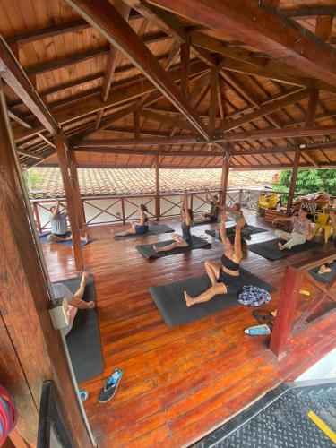 a group of people doing yoga in a building at La Vaina Cali in Cali
