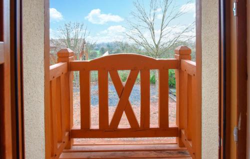 an open door to a porch with a wooden bench at 4 Bedroom Gorgeous Home In Valorbiquet in Saint-Julien-de-Mailloc