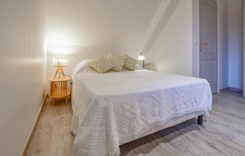 a bedroom with a bed with a white bedspread and two pillows at 4 Bedroom Gorgeous Home In Valorbiquet in Saint-Julien-de-Mailloc