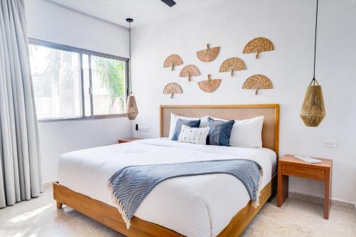a bedroom with a bed and a window at Casa Manglar Riviera Maya in Puerto Aventuras