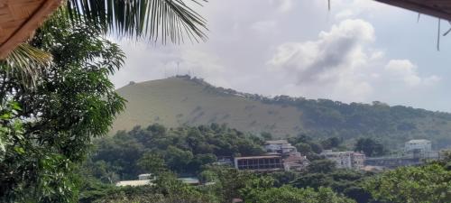 a mountain in the distance with houses and trees at Charming seaview chalet with AC, kitchen, downtown in Coron