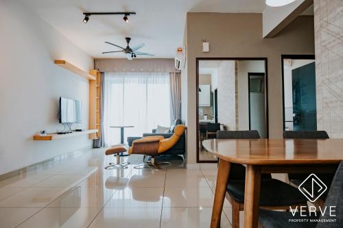 a dining room and living room with a table and chairs at Ipoh Majestic Premium Suites by Verve in Ipoh