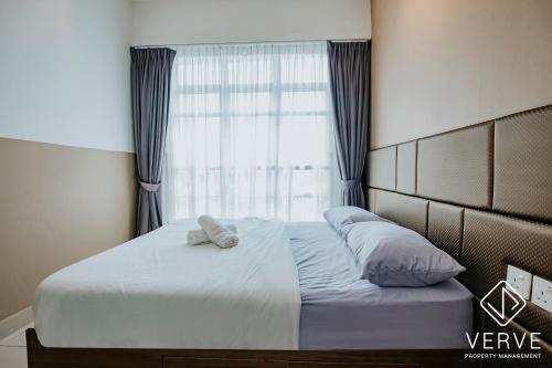 a bed in a bedroom with a large window at Ipoh Majestic Premium Suites by Verve in Ipoh