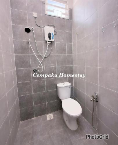 a bathroom with a toilet and a shower at Homestay Kulim, Cempaka Homestay Desa Kayangan in Kampong Padang Meha