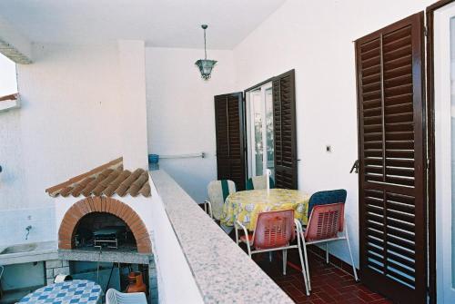 a balcony with a table and chairs and a fireplace at House Monika in Poreč