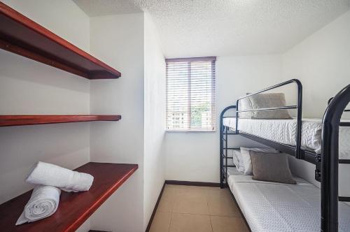 a room with two bunk beds and a couch at 9-26 Costa Linda Jacó Beach pool view Balcony in Jacó