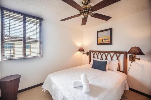 a bedroom with a bed with a ceiling fan at 9-26 Costa Linda Jacó Beach pool view Balcony in Jacó