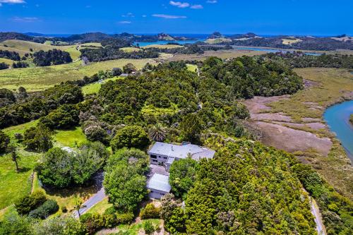 an aerial view of a house on a hill next to a river at Bruichladdich - Whangarei Private Room in Whangarei