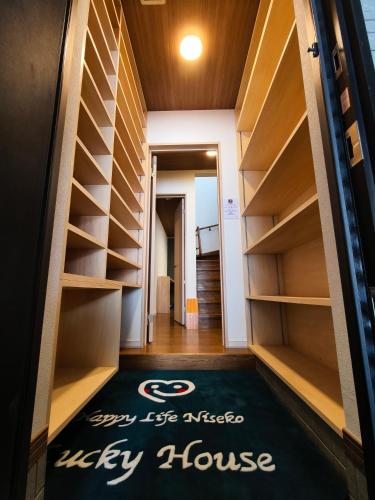 a hallway with a library house rug on the floor at Lucky House Niseko in Kutchan