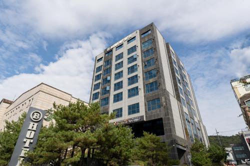 a tall building with a sign in front of it at Browndot Hotel Incheon Songdo in Incheon