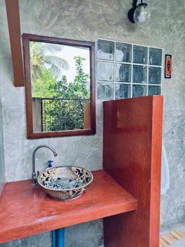 a bathroom with a sink and a mirror on a counter at Smilingface guesthouse in Sukhothai