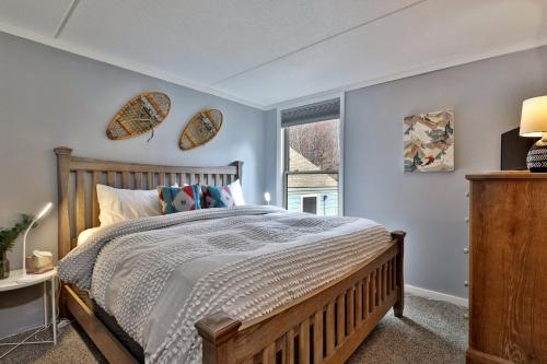 a bedroom with a wooden bed and a window at The Summit Suite at Whiffletree Vermont - Shuttle Bus, Pool, Summer Pool in Killington