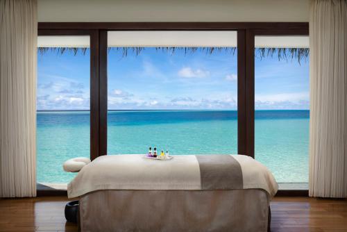 a room with a bed with a view of the ocean at Niyama Private Islands Maldives in Dhaalu Atoll