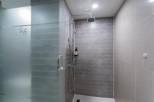 a shower with a glass door in a bathroom at Browndot Hotel Incheon Songdo in Incheon
