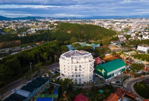 an aerial view of a white building in a city at CALYSSA HOTELS & VILLAGE in Khu Chi Lăng