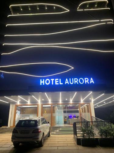 a car parked in front of a hotel aurora at Aurora Hotels and Resorts in Pulickamaly