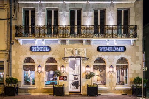 a building with a sign for a hotel at Hotel Vendome - BW Signature Collection in Vendôme