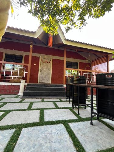 a building with chairs in front of it at Swaru Luxurious Villa in Tamhini Ghat & Kolad Rafting in Nizāmpur