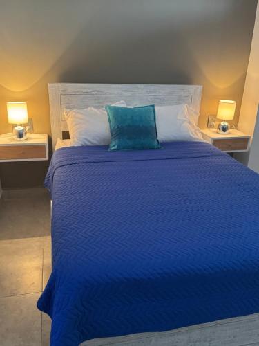 a blue bed with a blue pillow on top of it at Apartamento Blue Acapulco Diamante in Acapulco