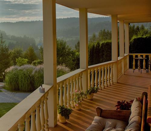 a porch of a house with a view of the mountains at Willa Wuja Sama in Zawóz