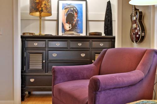 a living room with a purple chair and a dresser at Susan Lane Hideaway - 4BR, 3BA Renovated Home, Close to Skiing and Town, Fireplace in Rutland