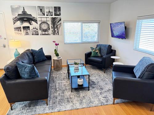 a living room with two couches and a table at Venice Beach Apartments Monthly rents in Los Angeles