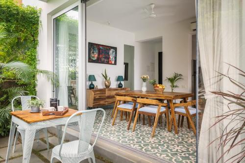 a dining room with a table and chairs at La Olalian 2 & 3 BHK Designer Villas Near Anjuna Beach with Private Pool & Sun Deck & Garden in Anjuna