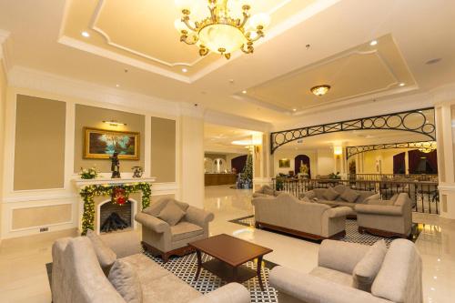 a living room with couches and a fireplace at CALYSSA HOTELS & VILLAGE in Khu Chi Lăng