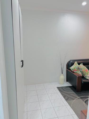 a living room with a couch and a vase at Harmony Heights in Lautoka
