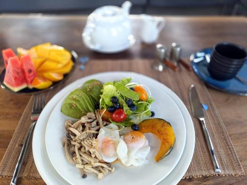 a plate of food with noodles and vegetables on a table at Chombua MaeWang ชมบัว in Chiang Mai