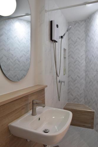 a bathroom with a sink and a shower at Squirrel House in Bang Rak