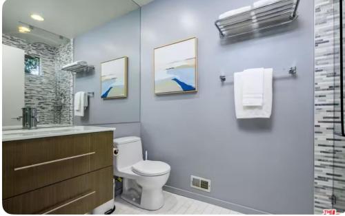 a bathroom with a toilet and a sink at Secluded Luxury Hollywood Hills Retreat in Los Angeles