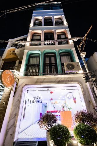 a tall building with a large window in front of it at Cosy Hotel in Ho Chi Minh City
