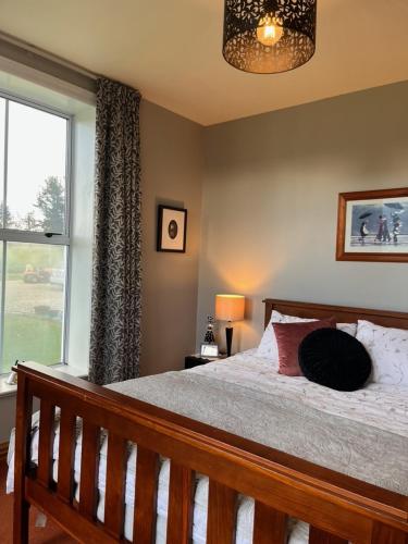 a bedroom with a bed and a large window at 74 on Lockhart in Oturehua