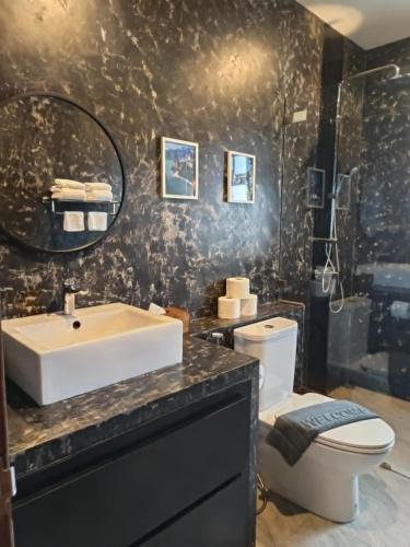 a bathroom with a sink and a toilet at Baan Suan Sawan Villa in Krabi town